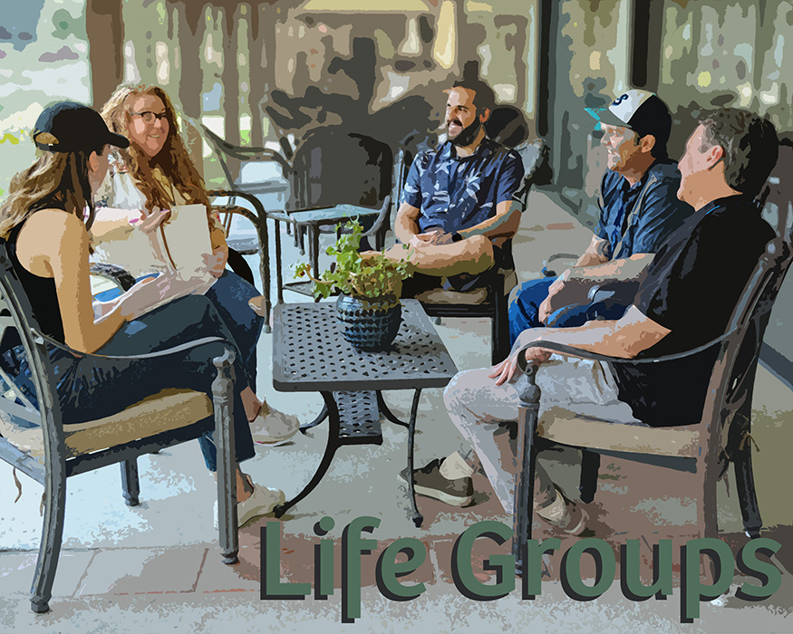 A Life Group of people sitting around a table talking and smiling.