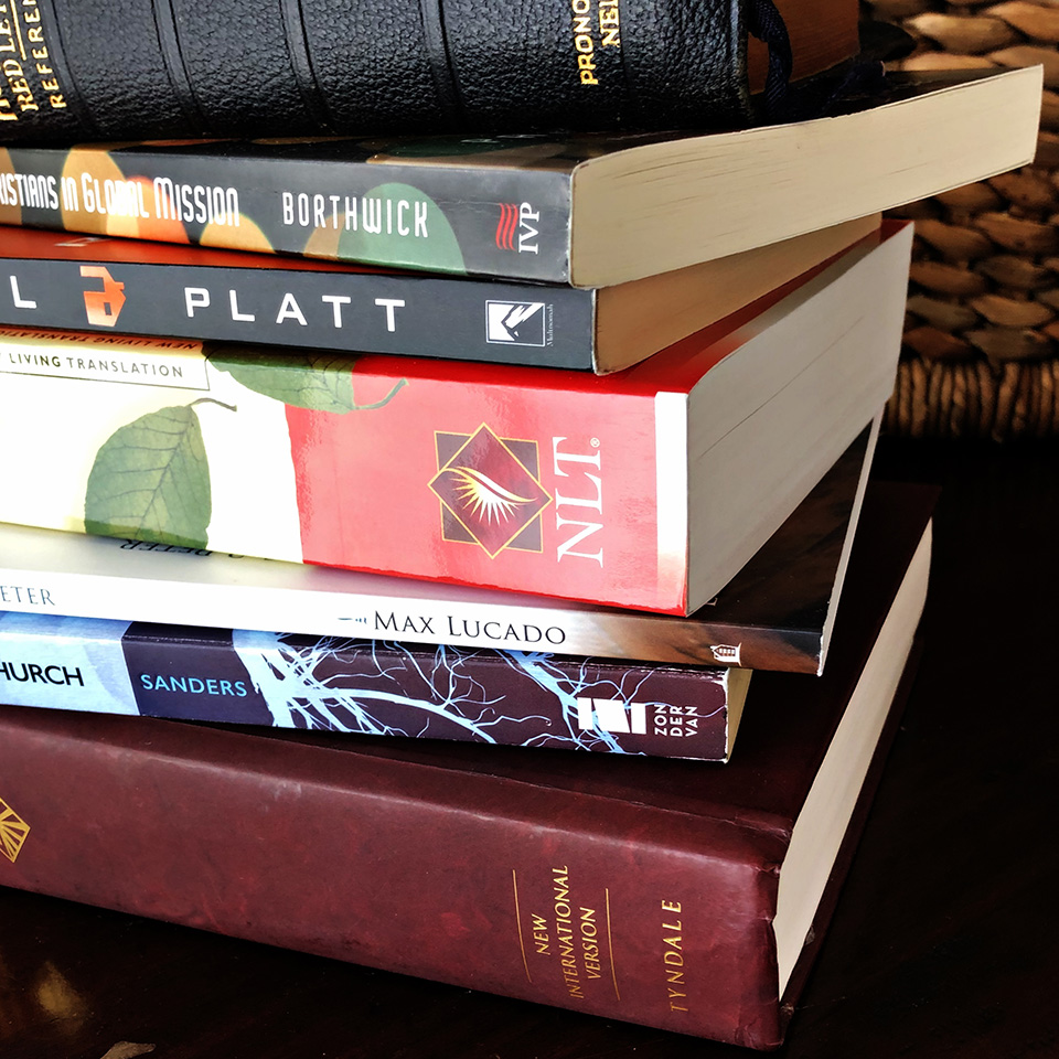 Several gently used Christian books and Bibles in a stack