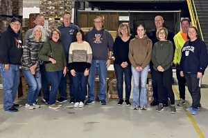 A Faith Lutheran Church Life Group poses in rows at Midwest Food Bank
