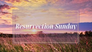 Resurrection Sunday text overlay on brilliant multicolor sunrise over a green field