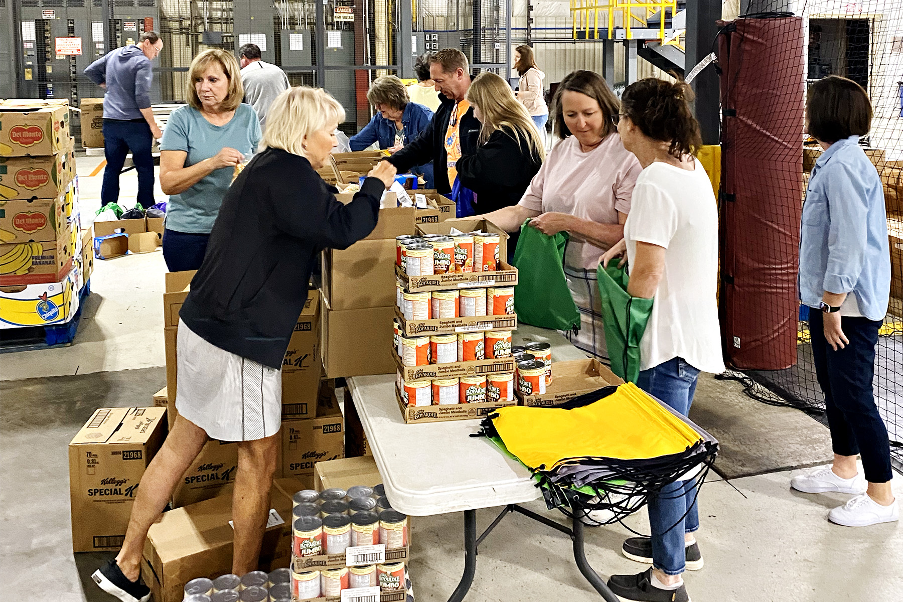 a group of Faith Lutheran Church of McLean County packing weekend food bags at Midwest Food Bank in Bloomington, Illinois