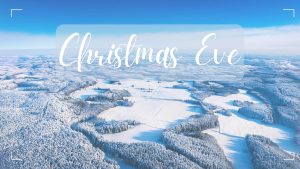 Christmas Eve written in script overlaid on gentle winter farmland scene viewed from an airplane. The image is associated with Christmas Eve worship of Faith Lutheran Church of McLean County in Bloomington Illinois