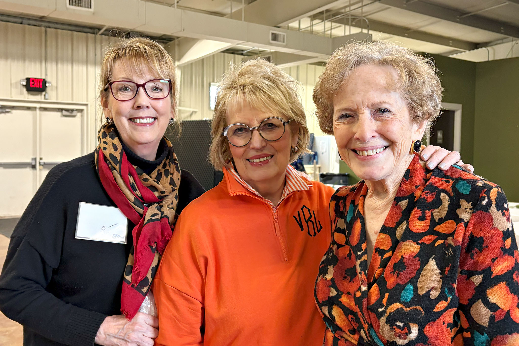 3 partners of Faith Lutheran Church of McLean County in Bloomington, Illinois look at the camera, smiling