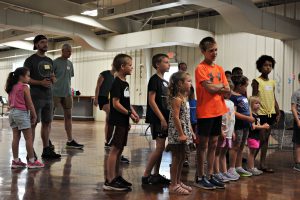 A group of children standing in a group preparing to sing during Faith Lutheran Church of McLean County - Faith Kids' Summer Music Camp 2025 Bloomington Illinois