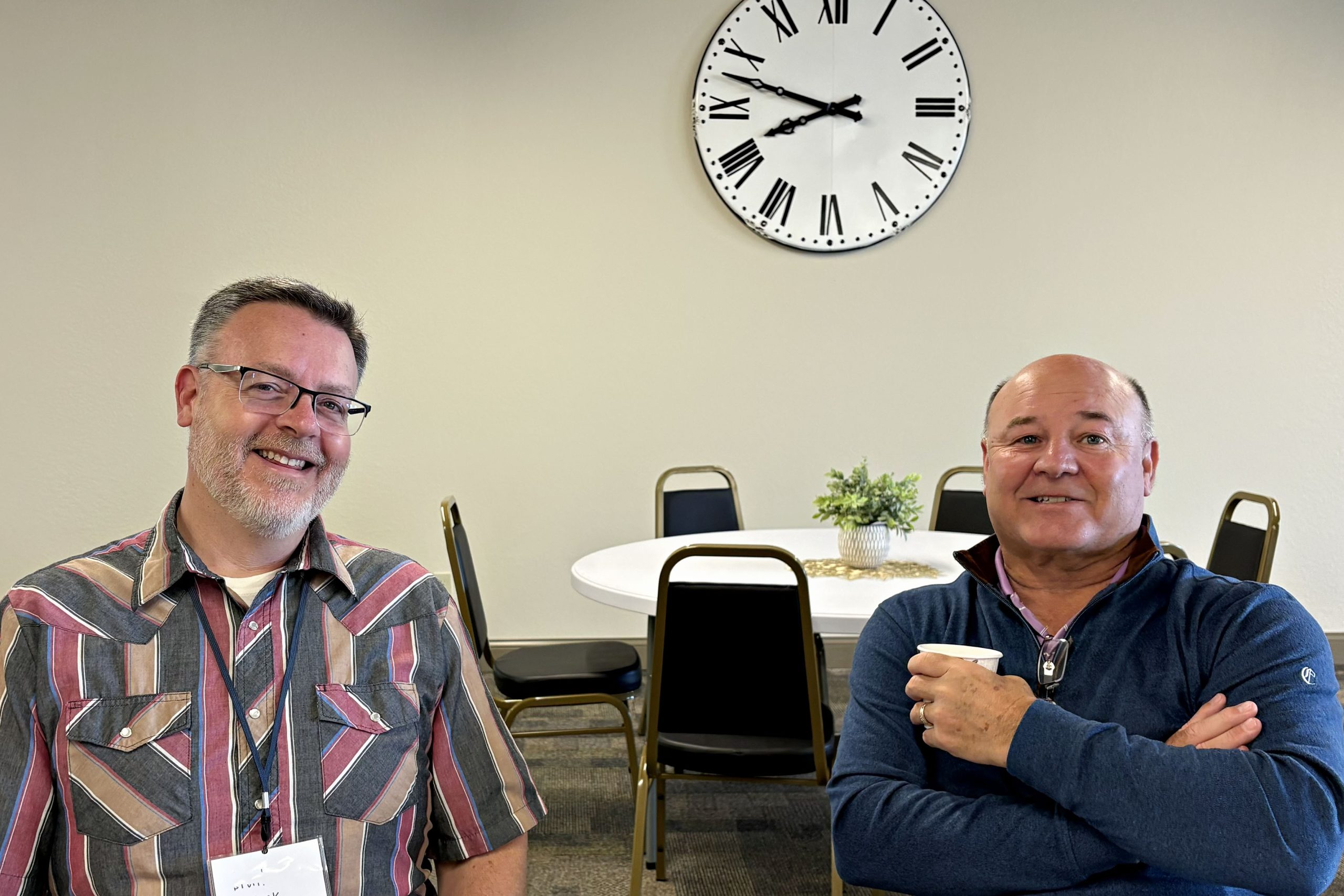 2 men enjoying coffee, seated at a table in the Fellowship Hall of Faith Church in Bloomington Illinois